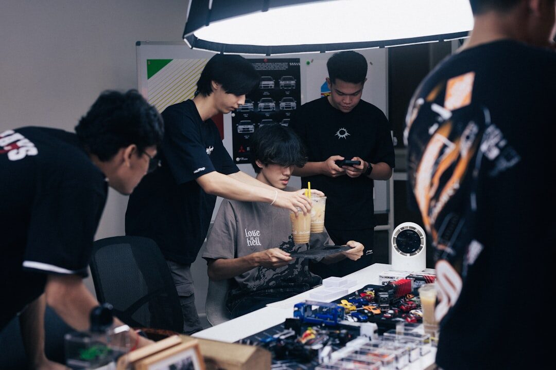 Small group of trainees learning around a table with a camera