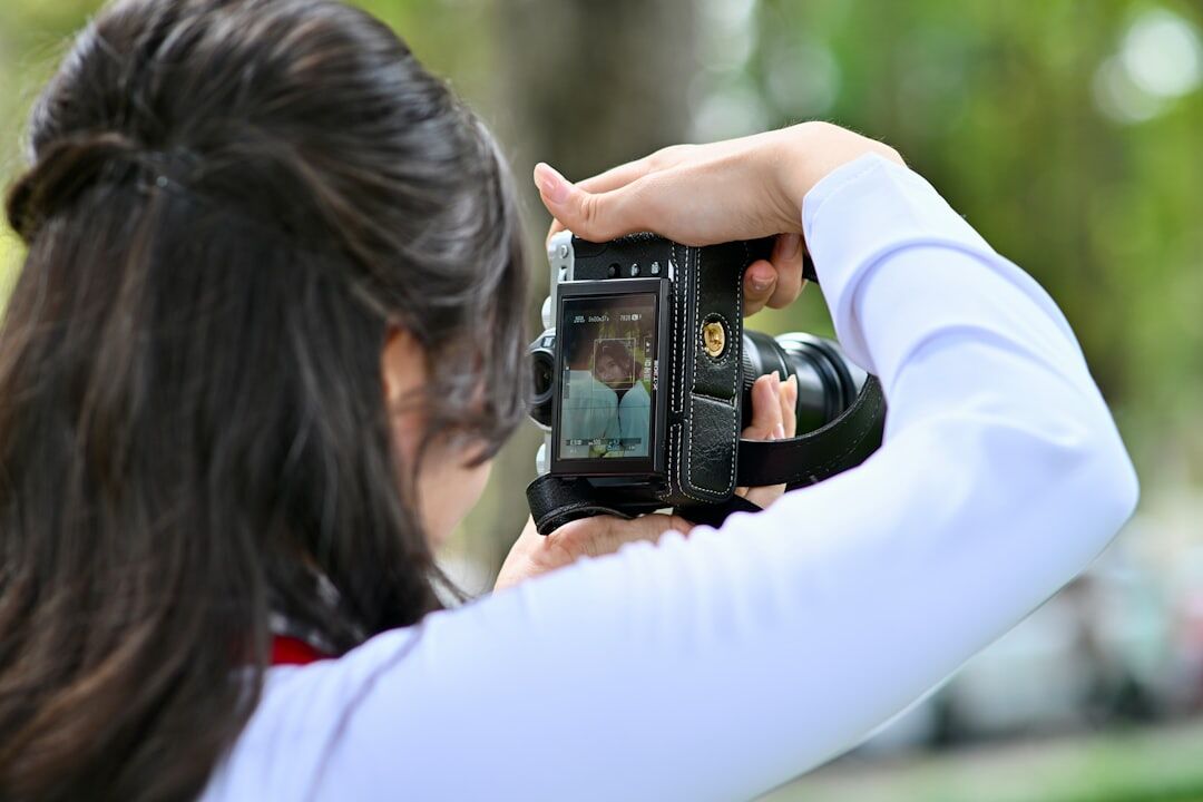 Camera operator framing a shot through a viewfinder