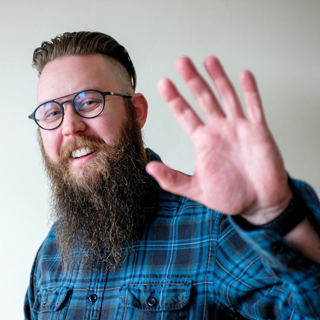 Portrait of a bearded man in glasses smiling